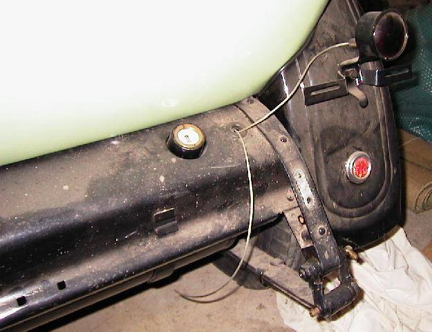 Rear quarter view showing fender flanging,  stoplamp